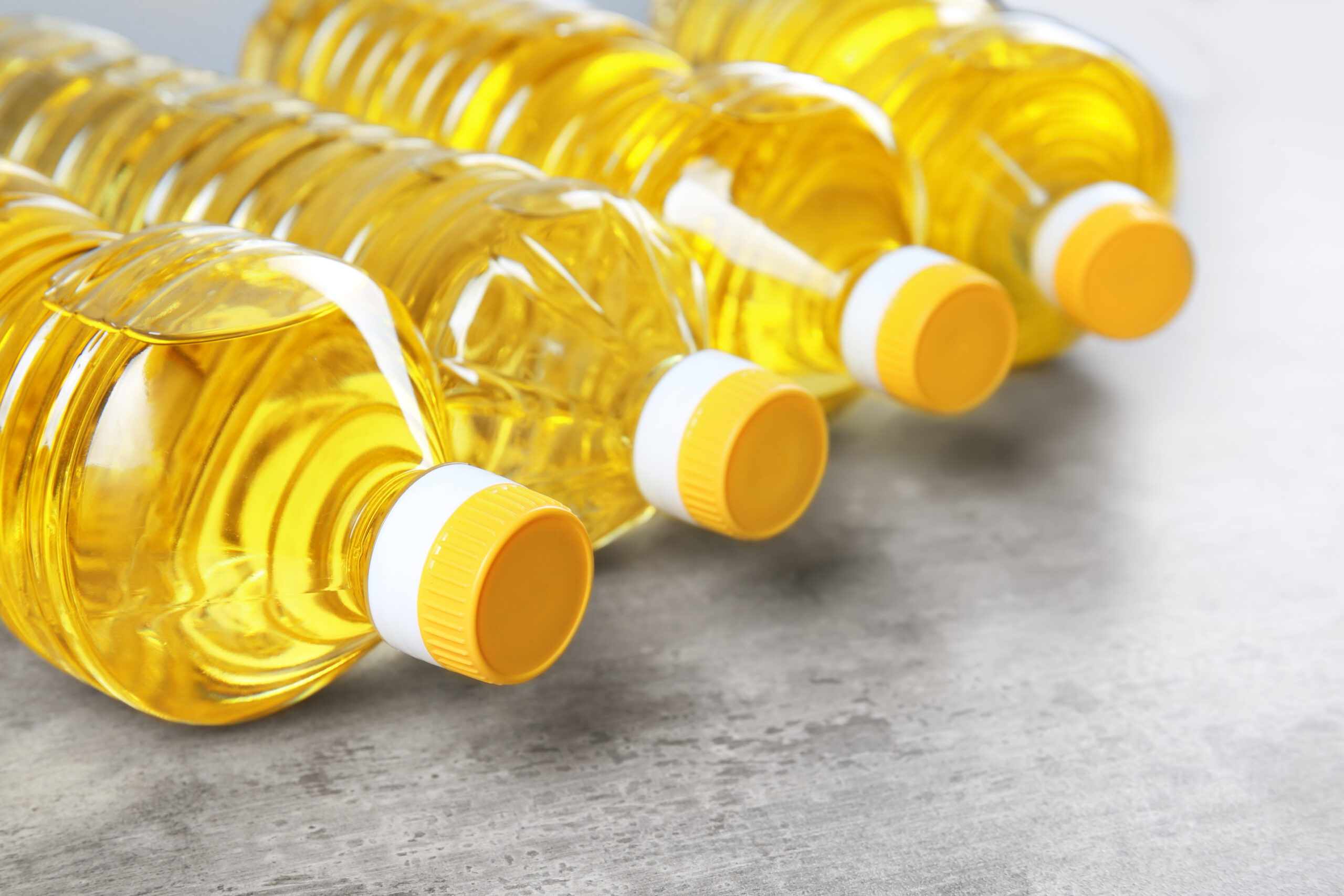 Bottles with cooking oil on table